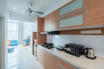 a kitchen with a microwave and a stove top oven at 2BR Maritime Suite Duplex George Town SeaView in George Town