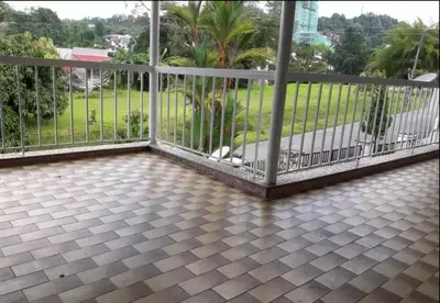 a balcony with a metal fence and palm trees at Taiping Lake View in Gua Sai