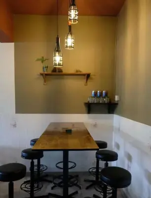 a table in a bar with stools in a room at Taiping Lake View in Gua Sai