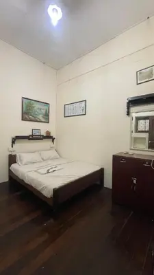 a bedroom with a bed and a window in it at Pearl Heritage Guesthouse in George Town