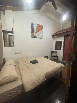 a bedroom with a large bed in a room at Pearl Heritage Guesthouse in George Town
