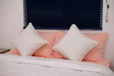 two pillows sitting on top of a bed at Yeop & Chor Homestay in Seri Iskandar