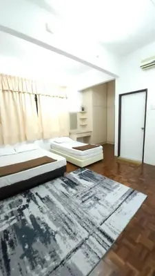 a living room with two beds and a rug at BUNGALOW POOL, NETFLIX, BBQ And BATU FERRINGHI in Batu Ferringhi