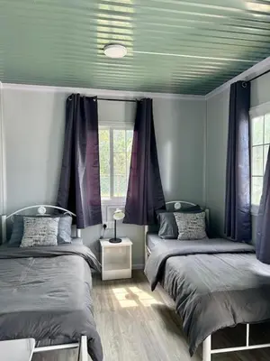 a bedroom with two beds and a green ceiling at TeeDo Zzz in Parit Buntar