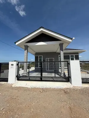 a small white house with a black fence at Adlisem Homestay in Kampong Lahar Yooi
