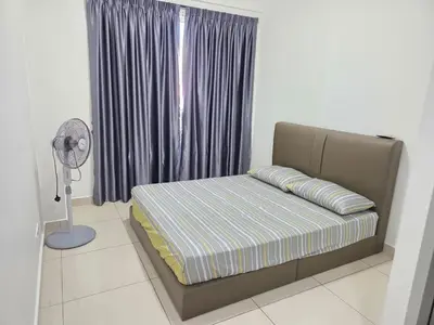 a bed in a room with a window and a fan at 3BR Condo near Queensbay, Penang in Bayan Lepas