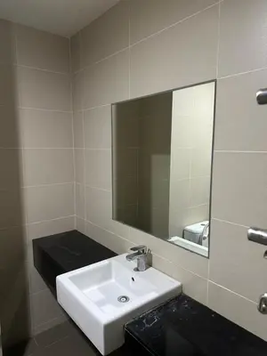 a bathroom with a white sink and a mirror at 3BR Condo near Queensbay, Penang in Bayan Lepas