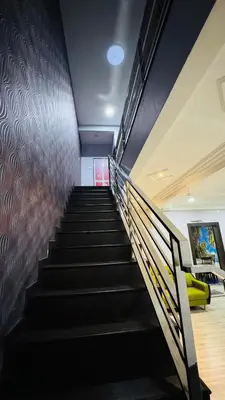 a staircase in a building with a yellow couch at Homestay, Lunas Kulim near BKE highway with 3 spacious rooms and fully furnished in Lunas