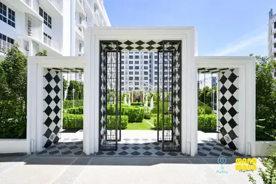 an open gate to a courtyard with buildings at Stallionz by Mana Mana in Ipoh