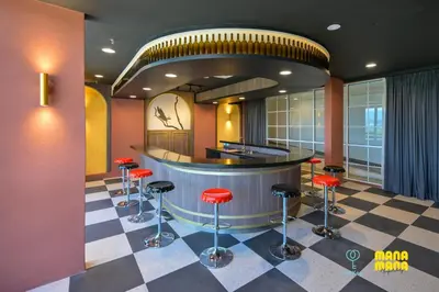a lobby with a bar with red stools at Stallionz by Mana Mana in Ipoh