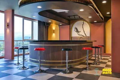 a bar in a restaurant with red stools at Stallionz by Mana Mana in Ipoh