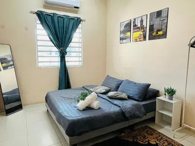 a bedroom with a blue bed with a window at Izzu Homestay Sungkai in Sungkai