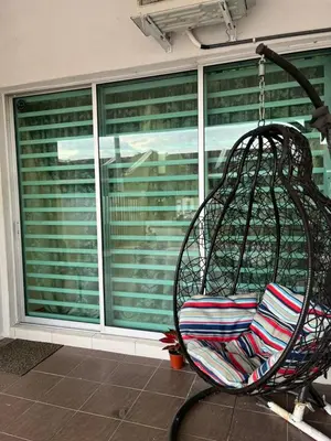 a swing in front of a window at Izzu Homestay Sungkai in Sungkai