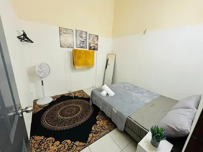 a small bedroom with a bed and a rug at Izzu Homestay Sungkai in Sungkai