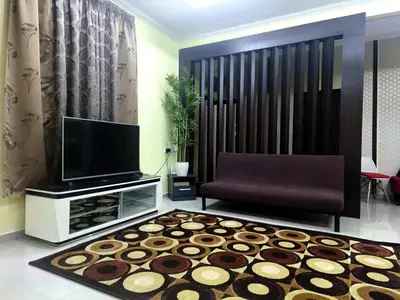 a living room with a tv and a rug at Dreamy Stay Penang in Butterworth