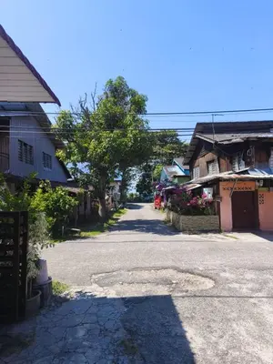 an empty street in a small town with houses at Dreamy Stay Penang in Butterworth