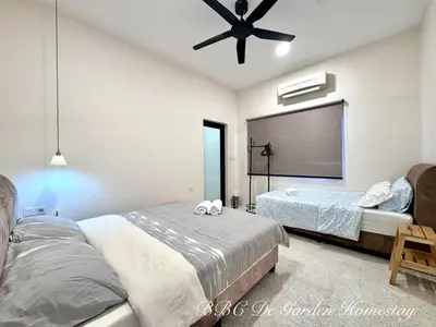 a bedroom with two beds and a ceiling fan at BBC De Garden Homestay in Ipoh