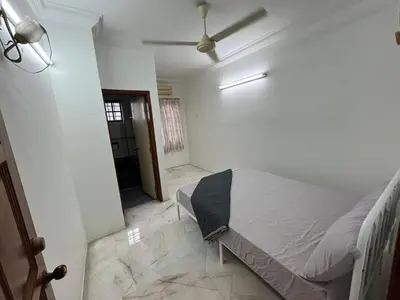 a bedroom with a bed and a ceiling fan at Garden vibe STAYcation Hillside in Ipoh