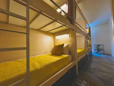 a bedroom with two bunk beds in a room at Strangerland Hostel in Ipoh