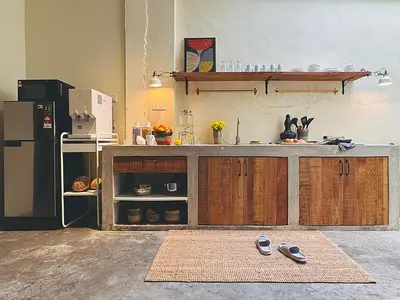 a kitchen with a counter and a refrigerator at Strangerland Hostel in Ipoh