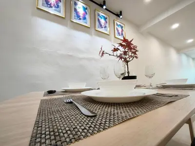 a wooden table with plates and glasses on it at K Room Homestay at Taiping in Taiping