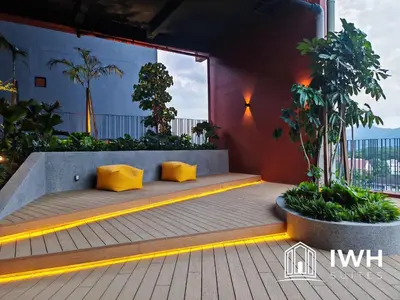 a bench with two yellow pillows on a balcony at Piccadilly Greentown Premium Suites by IWH Suites in Ipoh