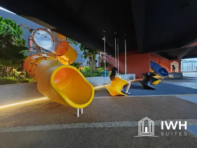 a playground with yellow slides and a yellow scooter at Piccadilly Greentown Premium Suites by IWH Suites in Ipoh