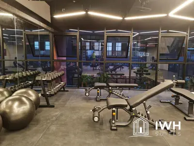 a gym with a bunch of weights and tread machines at Piccadilly Greentown Premium Suites by IWH Suites in Ipoh