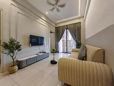 a living room with a couch and a flat screen tv at Piccadilly Greentown Premium Suites by IWH Suites in Ipoh