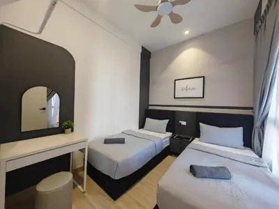 a hotel room with two beds and a mirror at Piccadilly Greentown Premium Suites by IWH Suites in Ipoh