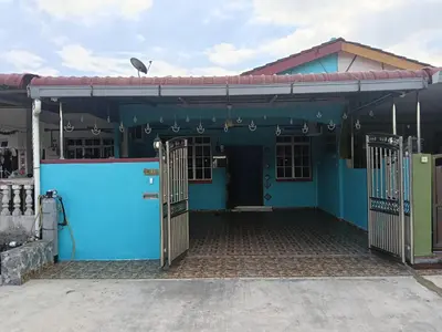 a blue house with gates and a bird on the roof at Homestay Sayang in Ipoh