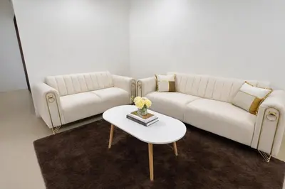 a living room with a white couch and a table at 525A Homestay Malim Nawar in Malim Nawar
