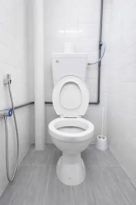 a bathroom with a white toilet in a stall at 525A Homestay Malim Nawar in Malim Nawar