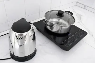 a blender sitting on a stove with a pot on it at 525A Homestay Malim Nawar in Malim Nawar