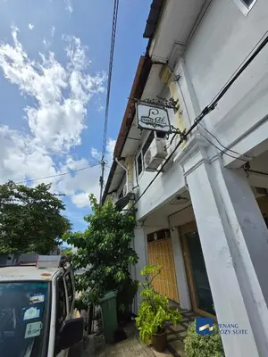a building with a sign on the side of it at Cozy Nanny House 2-6Pax #Georgetown #Hameediyah in George Town