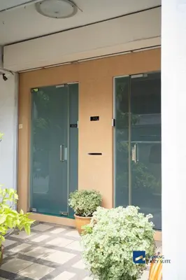 a glass door of a building with two plants at Cozy Nanny House 2-6Pax #Georgetown #Hameediyah in George Town