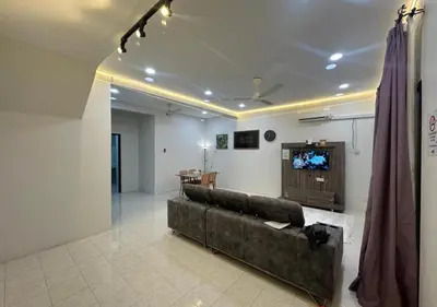 a living room with a couch and a tv at MRB Homestay in Ipoh