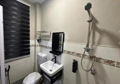 a bathroom with a shower and a toilet and a sink at MRB Homestay in Ipoh