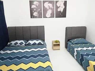 a bedroom with a bed and two pictures on the wall at twelve homestay ipoh in Ipoh