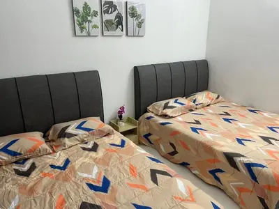 two beds sitting next to each other in a bedroom at twelve homestay ipoh in Ipoh