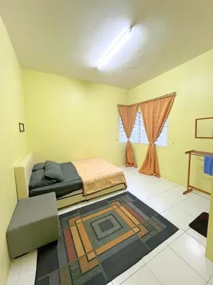 a bedroom with a bed and a rug on the floor at THE QUINTET BY D Atas Bukit Antarium in Tanah Rata