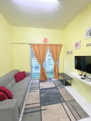 a living room with a couch and a large window at THE QUINTET BY D Atas Bukit Antarium in Tanah Rata