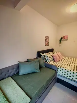 a bedroom with a bed with a green mattress at ZE Emerald Avenue,Brinchang in Brinchang