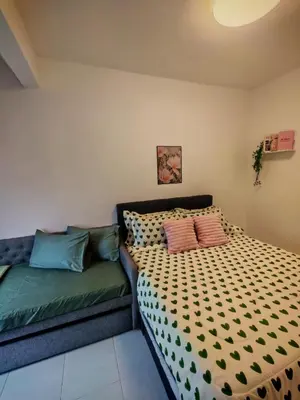 a bedroom with a bed and a couch at ZE Emerald Avenue,Brinchang in Brinchang