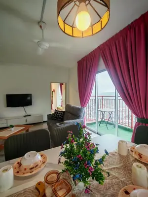 a living room with a table with a christmas tree on it at ZE Emerald Avenue,Brinchang in Brinchang