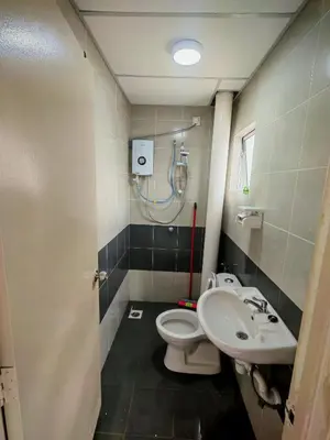 a bathroom with a toilet and a sink at ZE Emerald Avenue,Brinchang in Brinchang