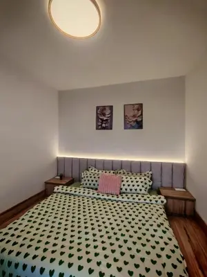 a bedroom with a bed with a black and white comforter at ZE Emerald Avenue,Brinchang in Brinchang