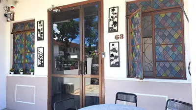 an entrance to a house with stained glass doors at MediSehat KamarKu - Just 20 meters to Gleneagles Hospital Penang in George Town