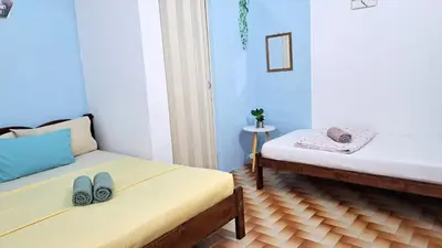 a room with two beds and two pairs of shoes at MediSehat KamarKu - Just 20 meters to Gleneagles Hospital Penang in George Town
