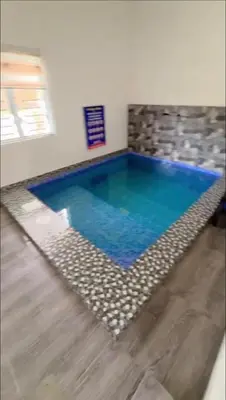 a large swimming pool in a room at De Bagan Village, Tanjong Karang in Tanjung Karang